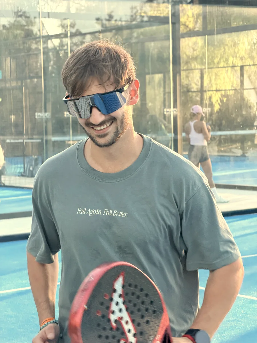 One of the coaches smiling in the Fail Again. Fail Better. shirt